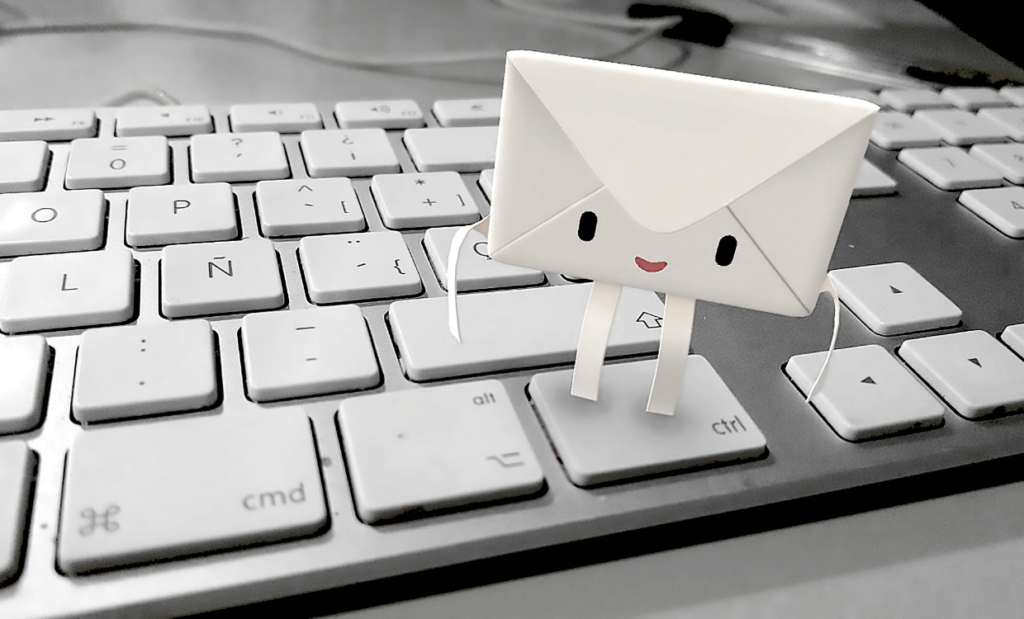 Friendly papercraft envelope character standing on a keyboard representing Ordaxi customer support